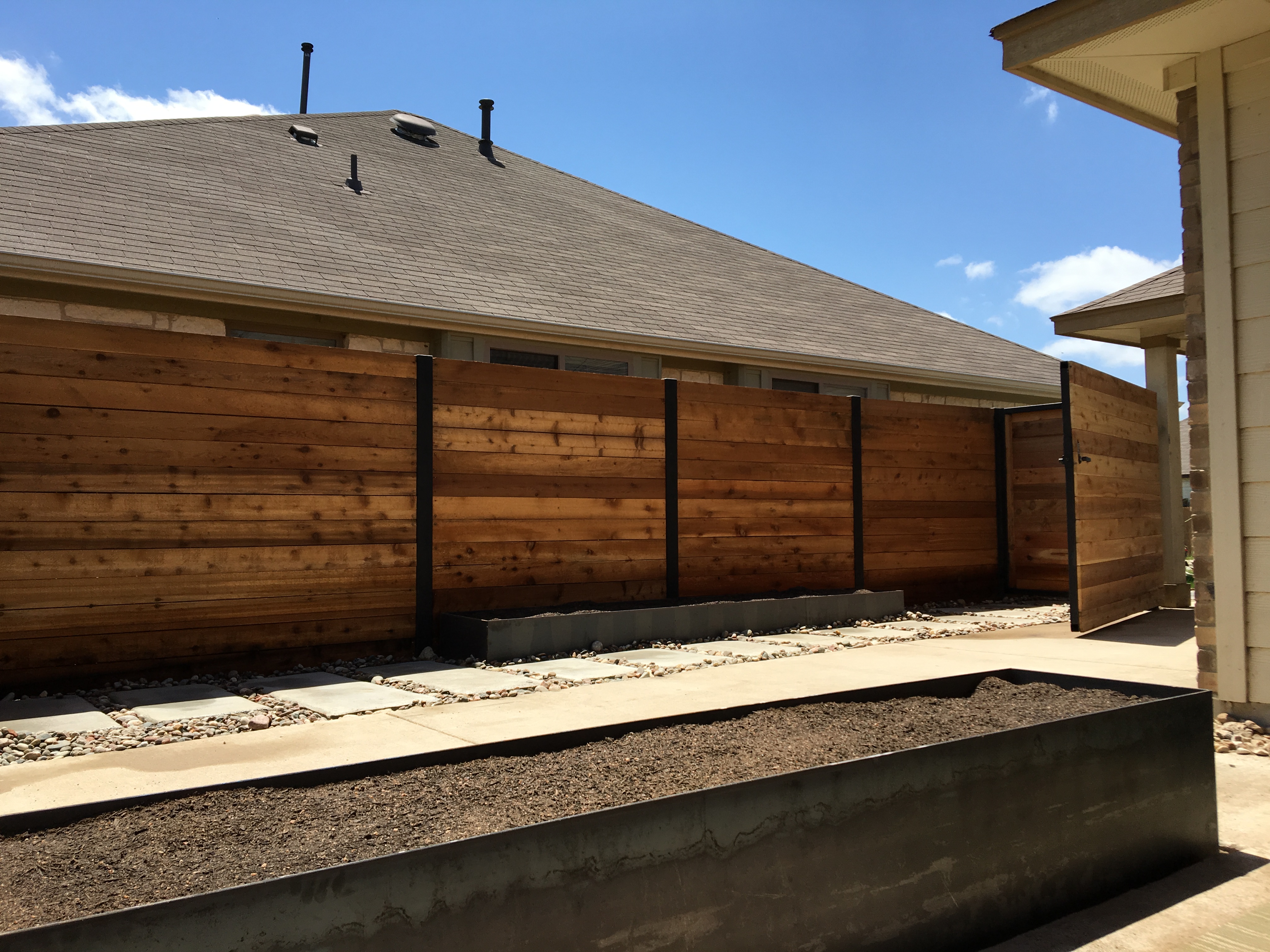 Steel planter beds, custom cedar fence