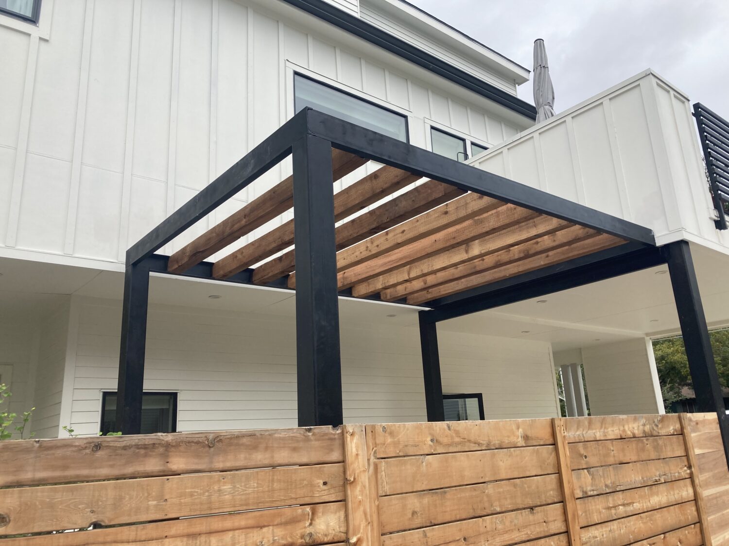 Austin landscape and design - steel paragola with cedar beams